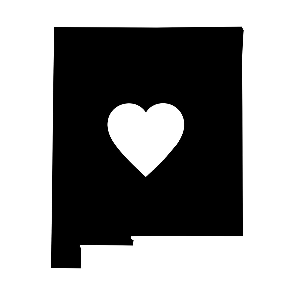 Black New Mexico state shape sticker with a white heart cut out of the center
