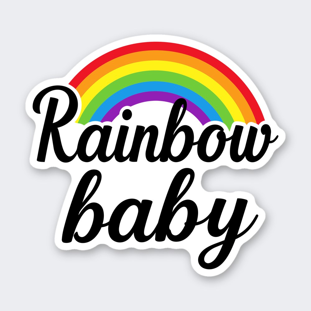 Rainbow baby in black brush script beneath a seven-color rainbow arc